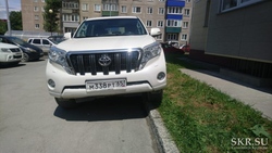 В Южно-Сахалинске водитель на белом «Прадо» ставит машину на бордюре